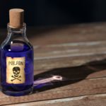purple-liquid-poison-on-brown-wooden-surface-159296